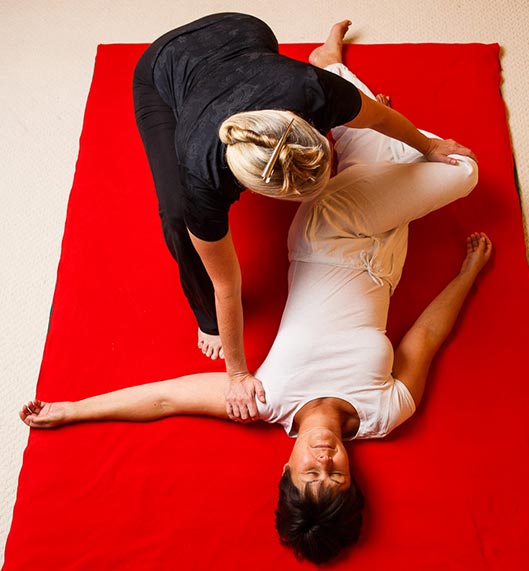 Shiatsu massage on the floor on heated matt